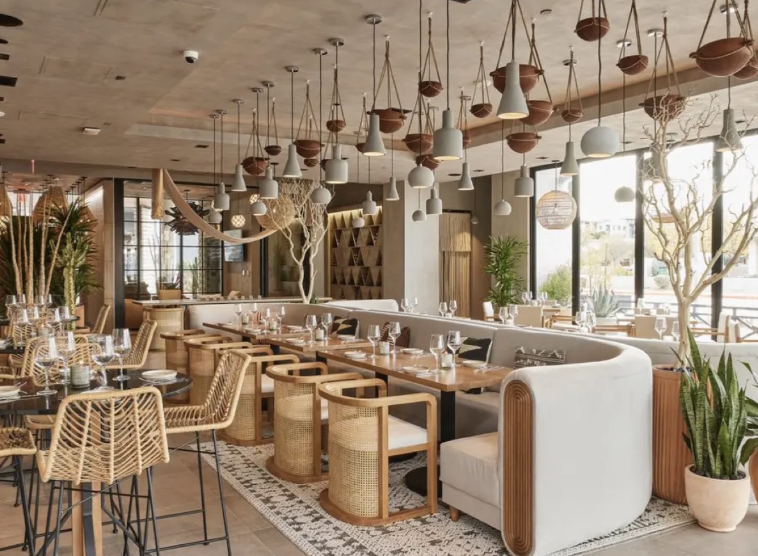Bright Mediterranean dining room with rattan chairs at Cala Scottsdale in Old Town Scottsdale