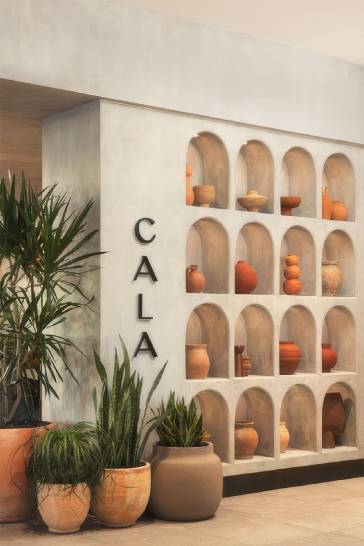 Cala signage wall with terracotta pottery in arched niches at Cala Scottsdale