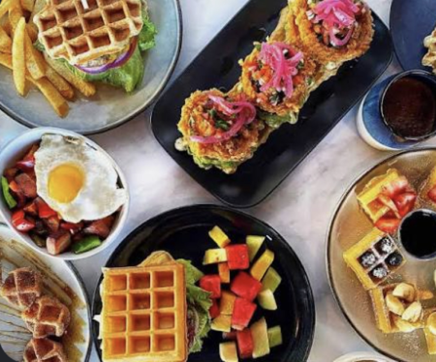 Breakfast and brunch spread of waffles, chicken and waffles, fruit and eggs at Honey & Herb in Thousand Oaks